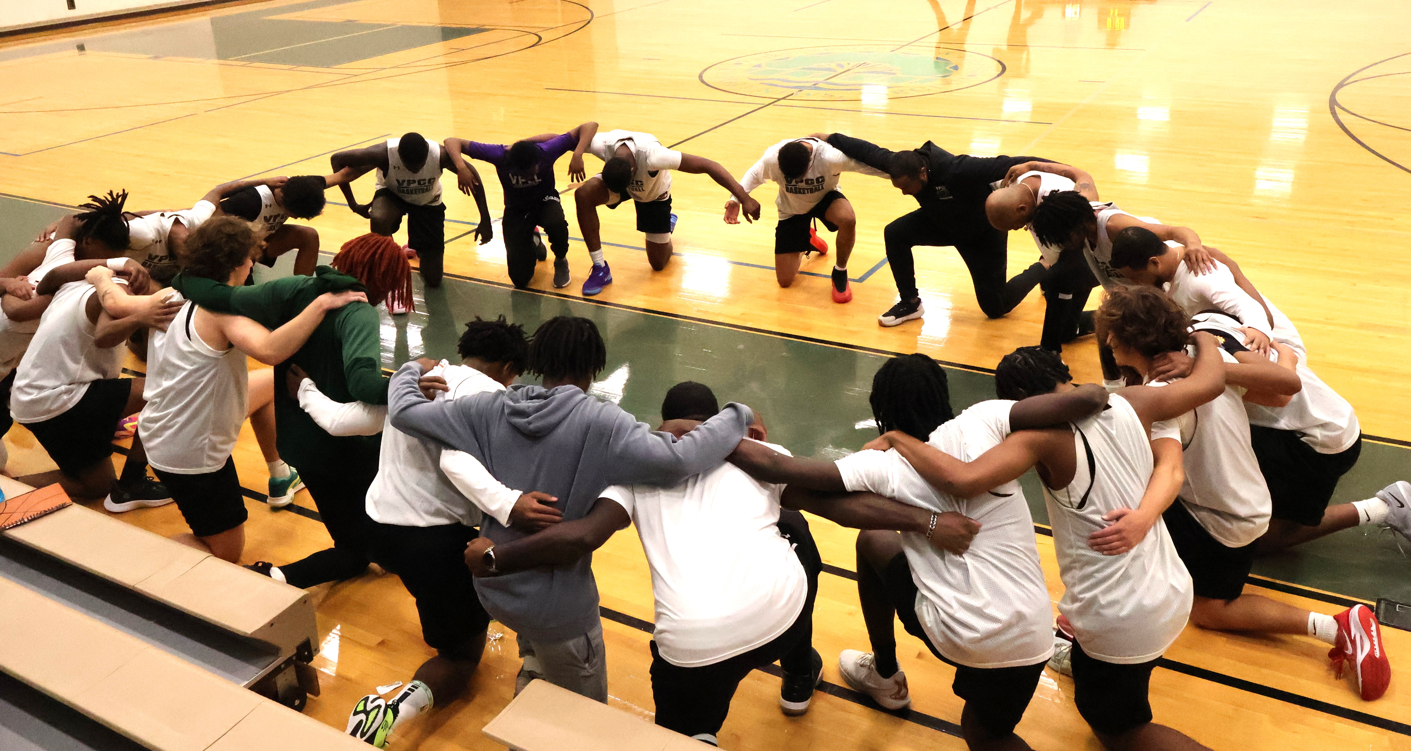 VPCC basketball players gather before a scrimmage