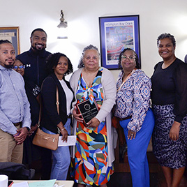 Angela Jackson (center) was surrounded by her daugthers and representatives from the VPCC athletics department after receiving her award.