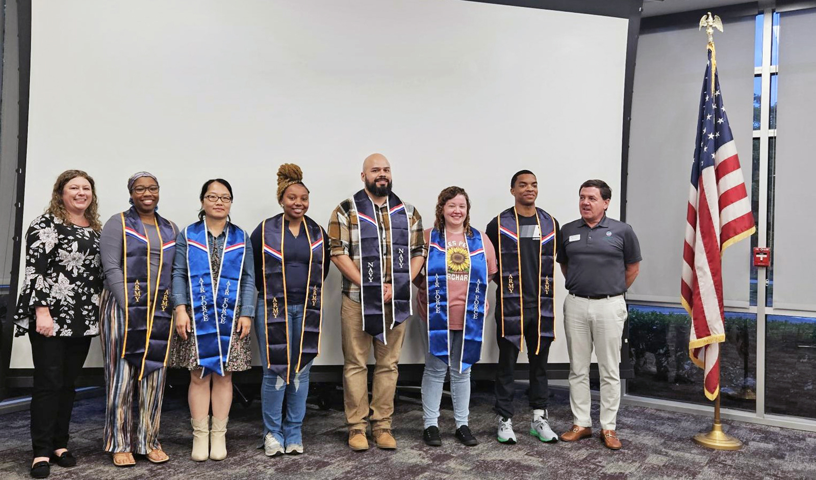 From left to right: Assistant Director of Military & Veterans Services Brandie Weaver, Rebekah McCall, Haihua Paige, Breona Alston, Jaime Ortiz, Amanda Grimes, Isaac Duncan, and Director of Financial Aid and Military & Veterans Services Marc Vernon.