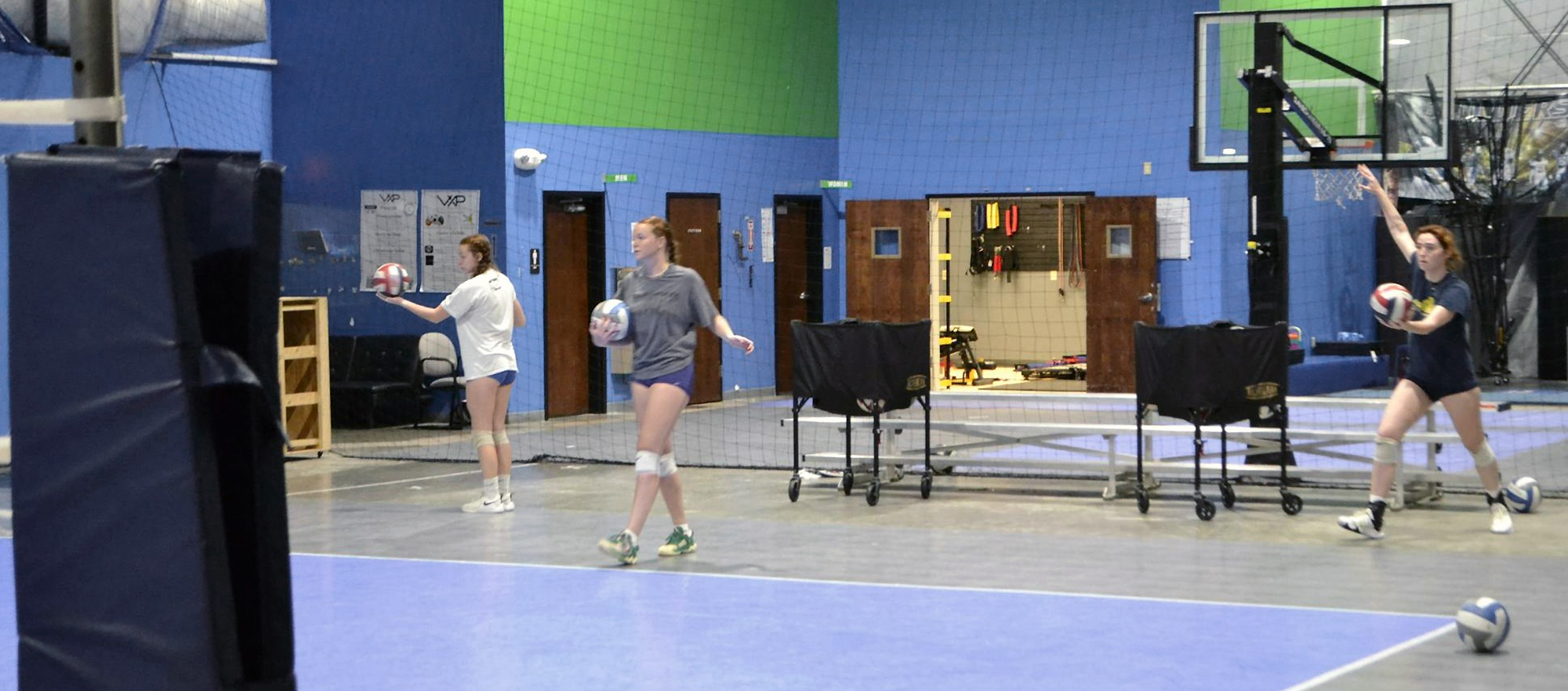 Volleyball players hit the gym for their first workout.