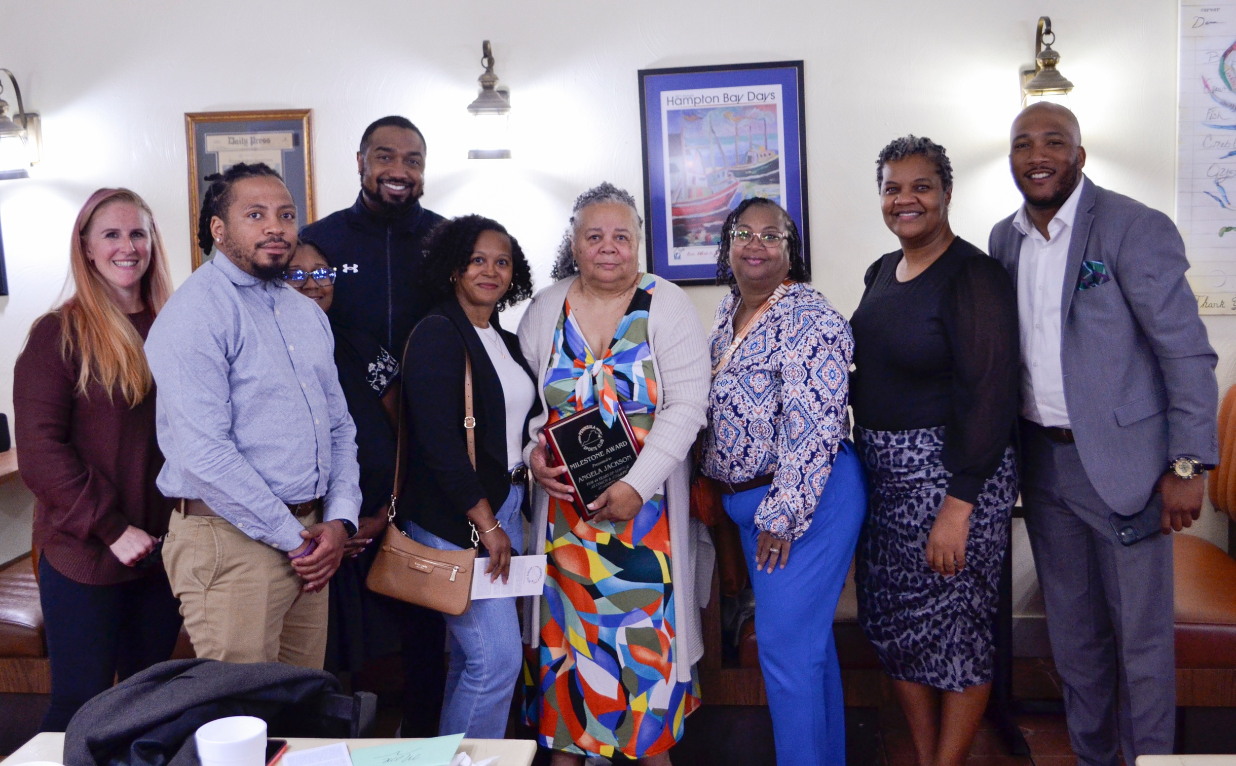 Coach Angela Jackson (center) is surrounded by family and VPCC representatives.