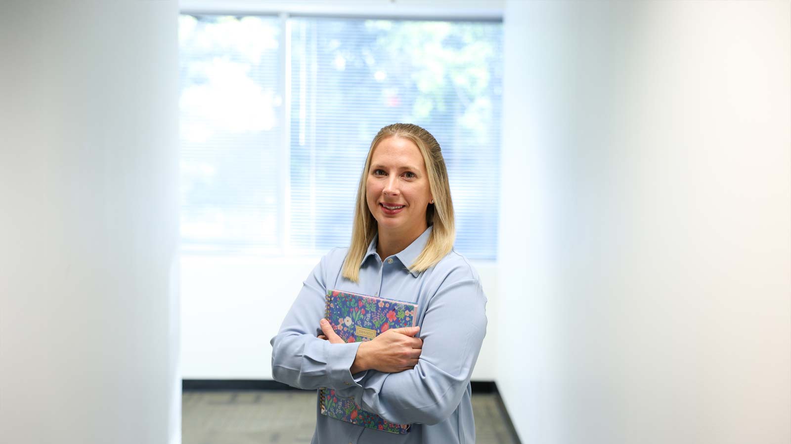 faculty member holding a book