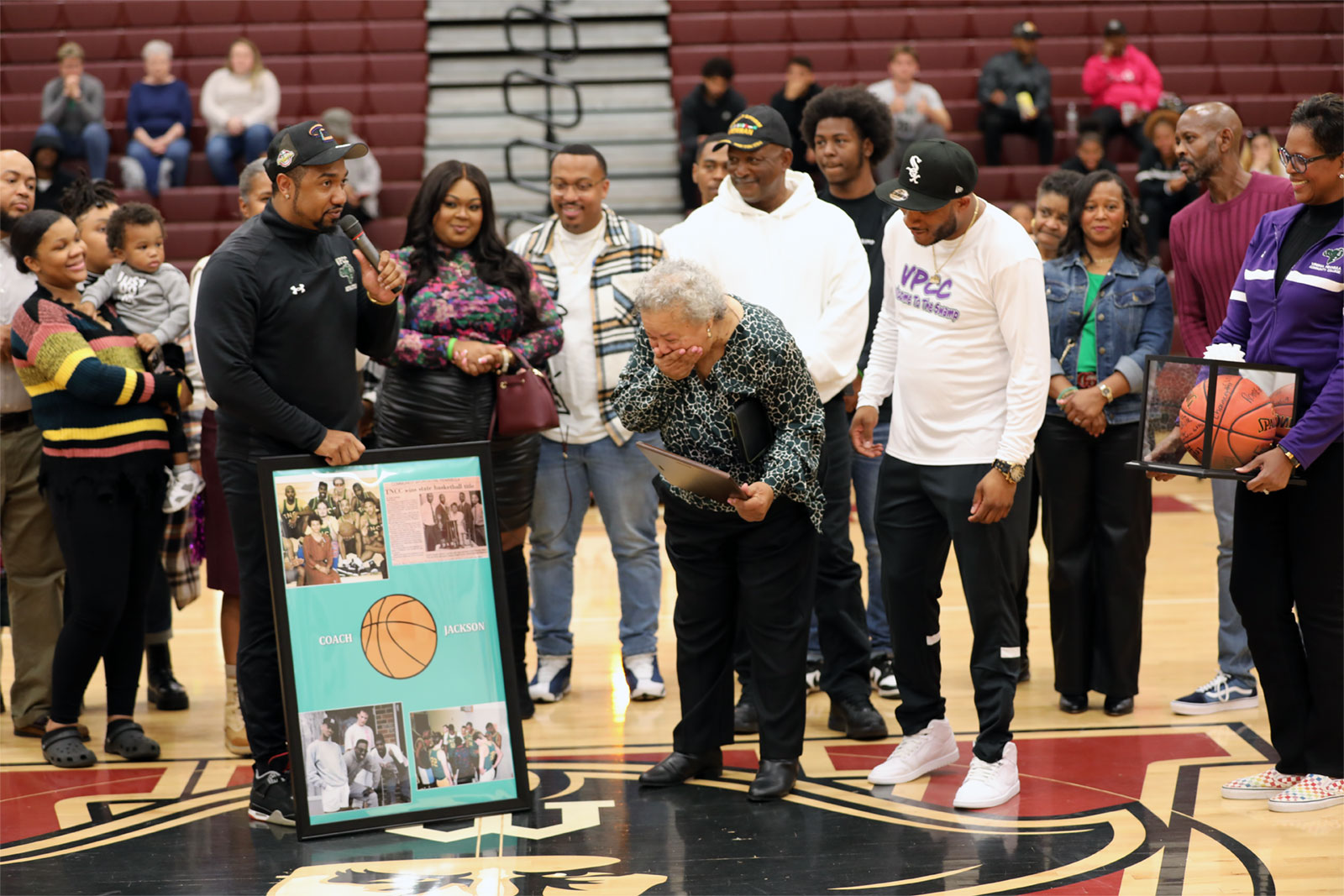 Coach Chris Moore recognized Angela Moore during Gator Madness ceremony