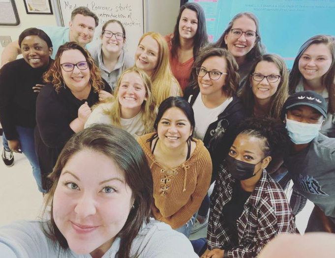 Jenni Jones (third row, left wearing glasses and black dress) taught her final group of students in the spring. They will graduate in December.