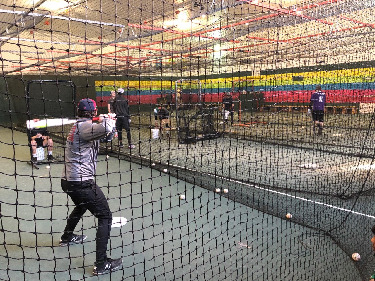 The College's baseball team practicing indoors