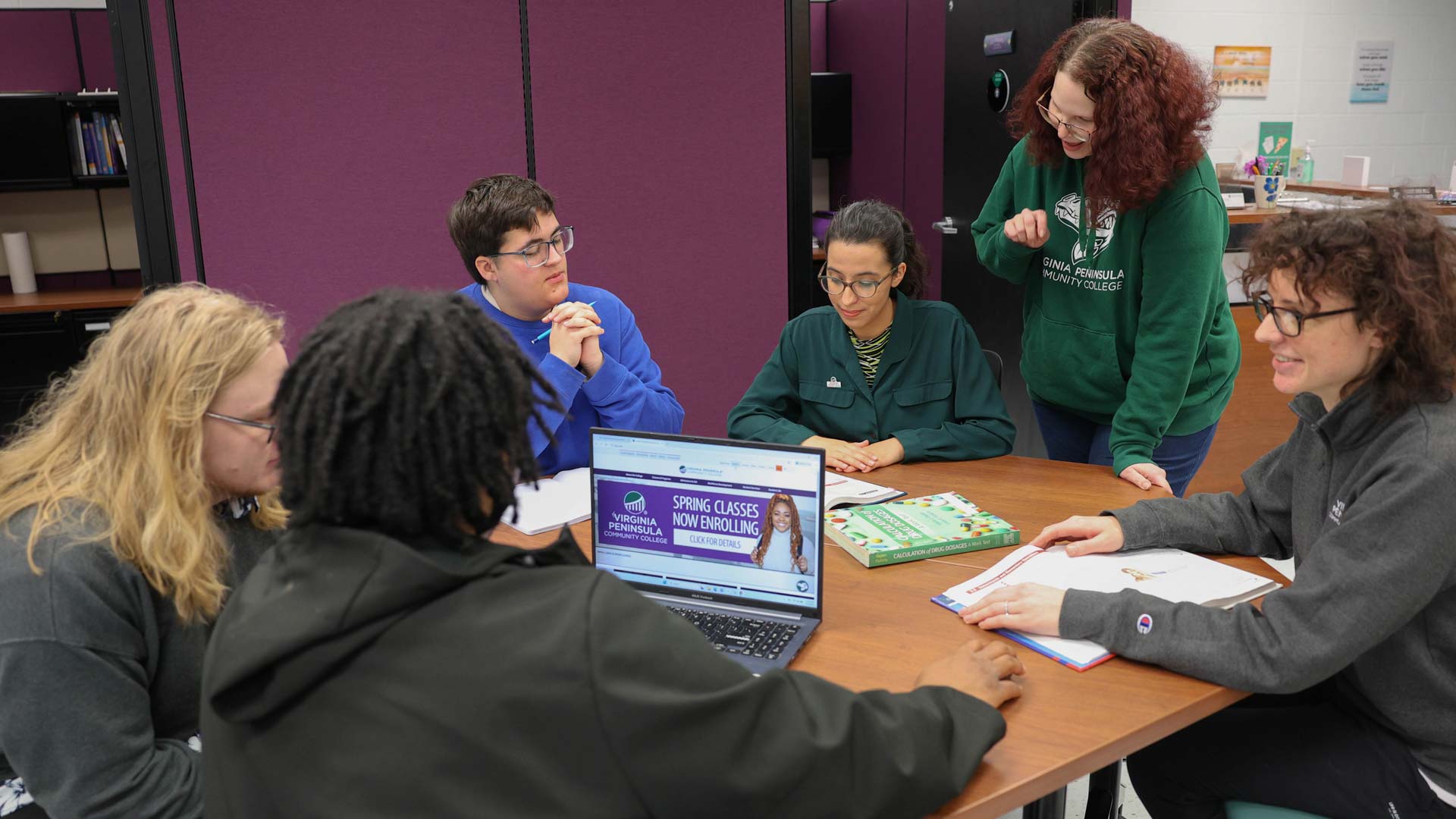 Lizz Rizzatto (standing) is excited the Tutoring Center has moved into a bigger space in Kecoughtan Hall.